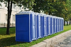 Line of porta potties on a grass patch