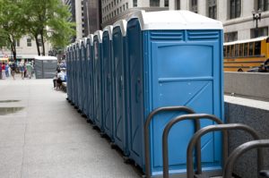 porta potties in a line next to a path